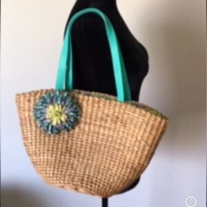 WOVEN straw shoulder bag purse bucket bag with flower embellishment.